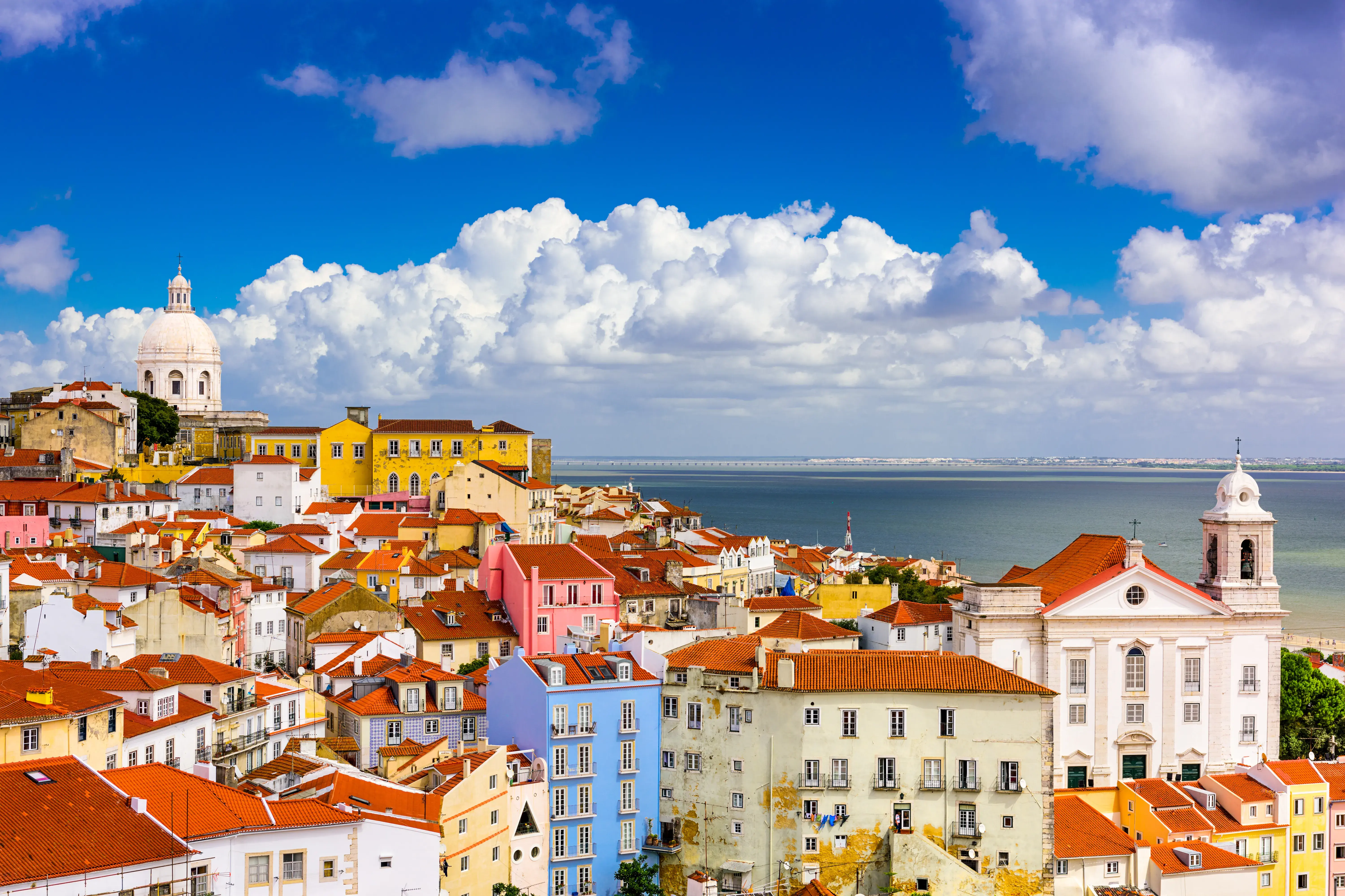 A large town in Portugal sitting next to a large body of water