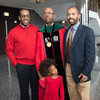 President Drake poses with his two sons and granddaughter. (Photo by Jo McCulty)