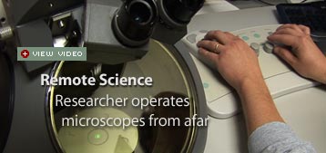 Researcher operates microscopes from afar