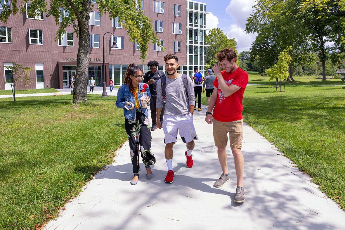 Four masked students walk on campus at Ohio State Newark.