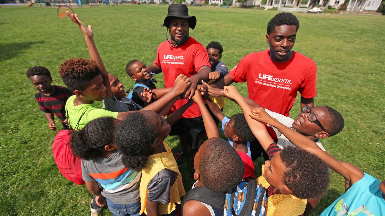 Instructors helping children with sports