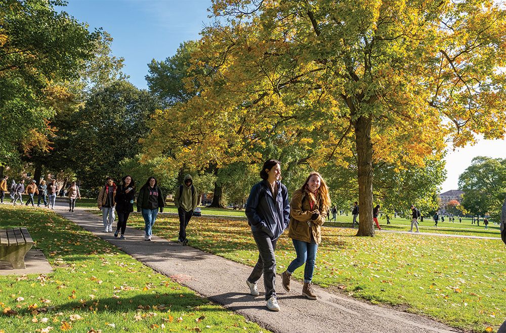 Students walking in the Oval on a sunny, fall day