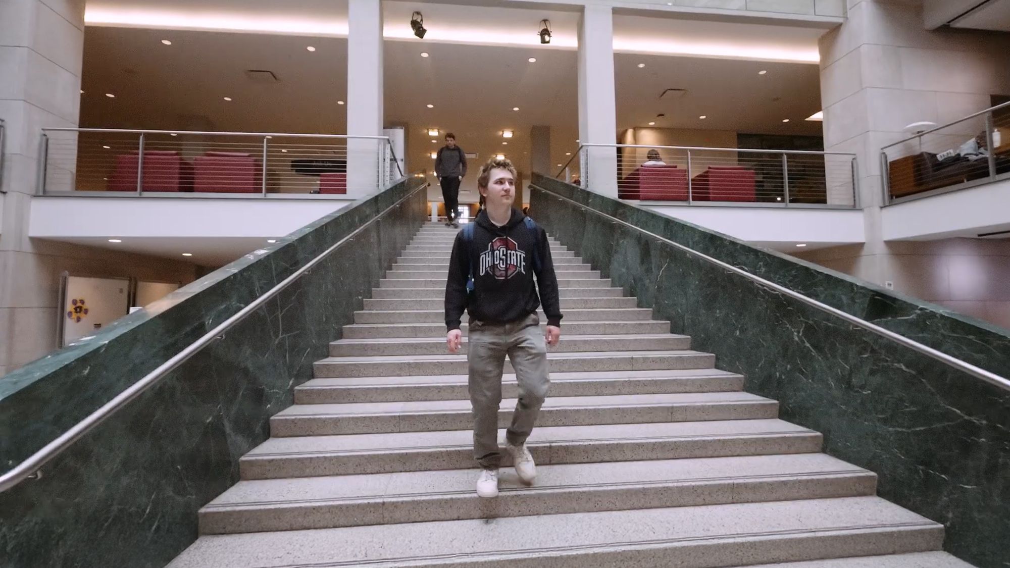 Jonah Clark walks down stairs at the Thompson Library on Ohio State's Columbus campus