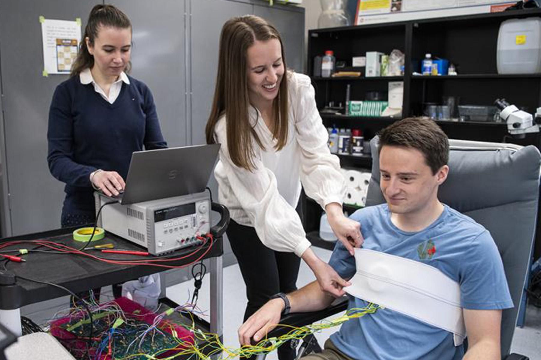 Prof. Asimina Kiourti (left) works with Ally Rice and fellow PhD student Connor Jenkins to test a wearable device in the ElectroScience Laboratory (photo by Logan Wallace).
