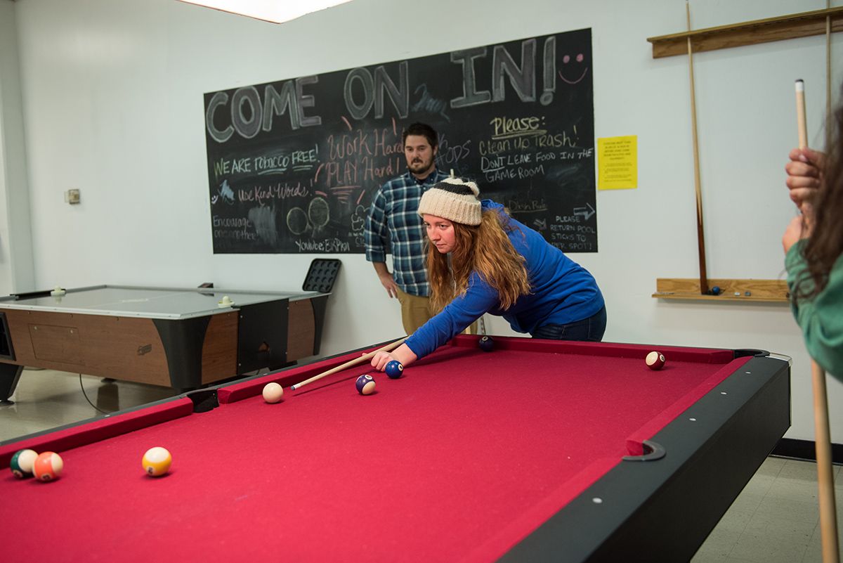A student shoots pool while another looks on at the Eisenhower Student Union on the Ohio State Mansfield campus.