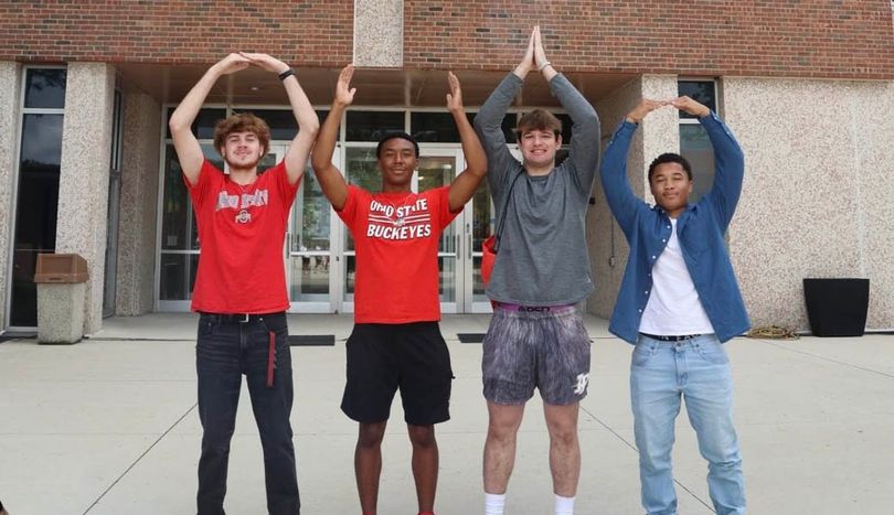 Four Ohio State students perform O-H-I-O