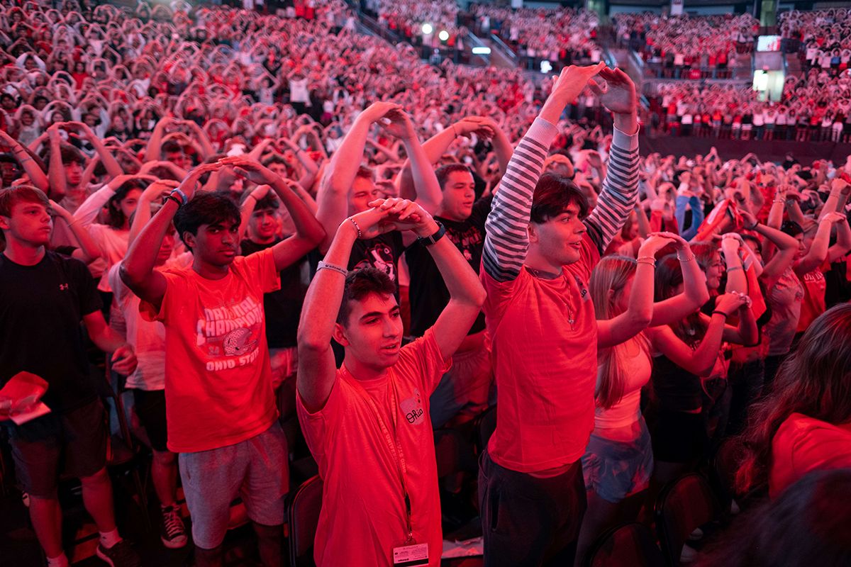 Thousands of first-year students make their arms in an "O" shape at the 2025 Convocation ceremony.