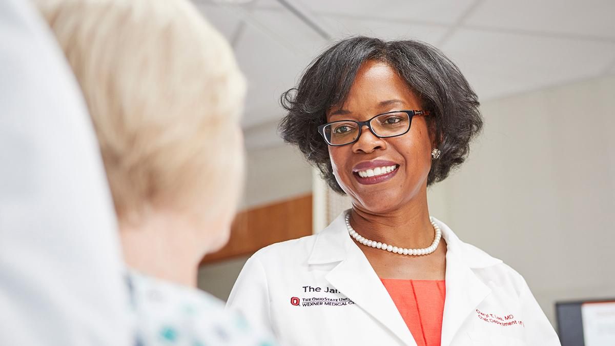 A doctor smiles at a patient