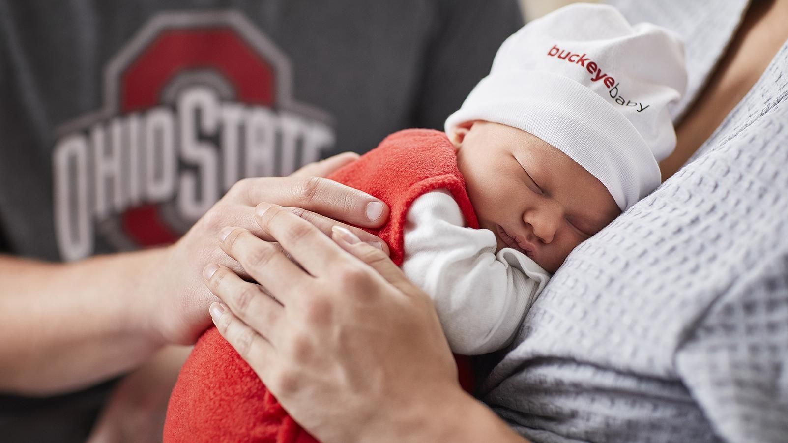 A newborn baby resting on a woman's chest