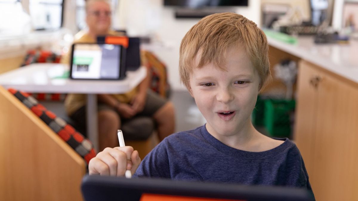 A student works with a stylus on a tablet