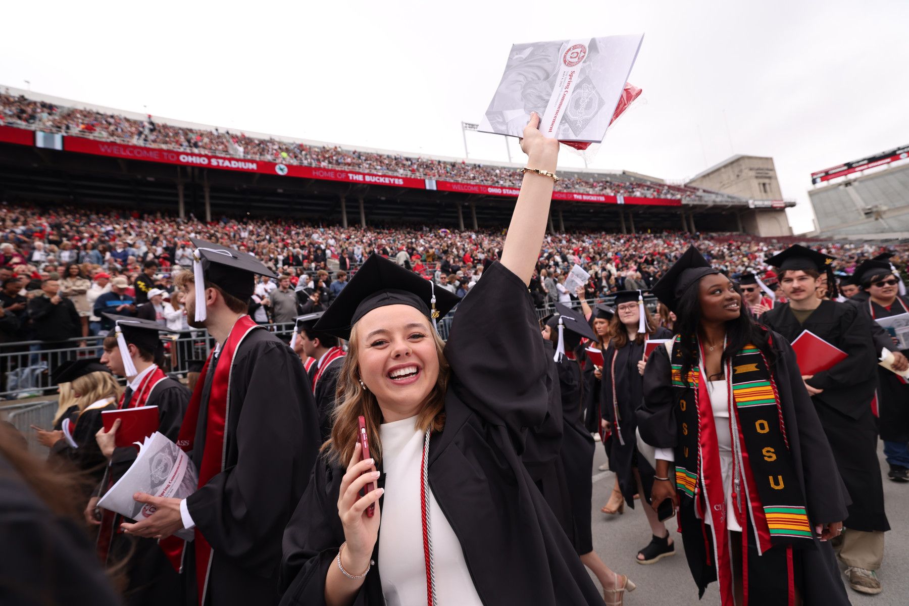 A graduate celebrates at Ohio State's 2025 spring commencement