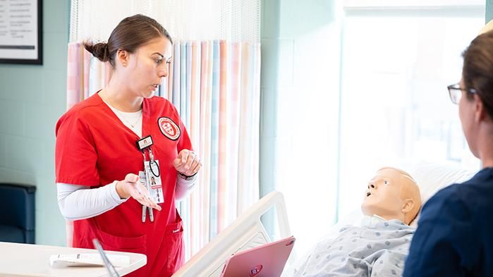 a nursing student practices clinical experience with patients