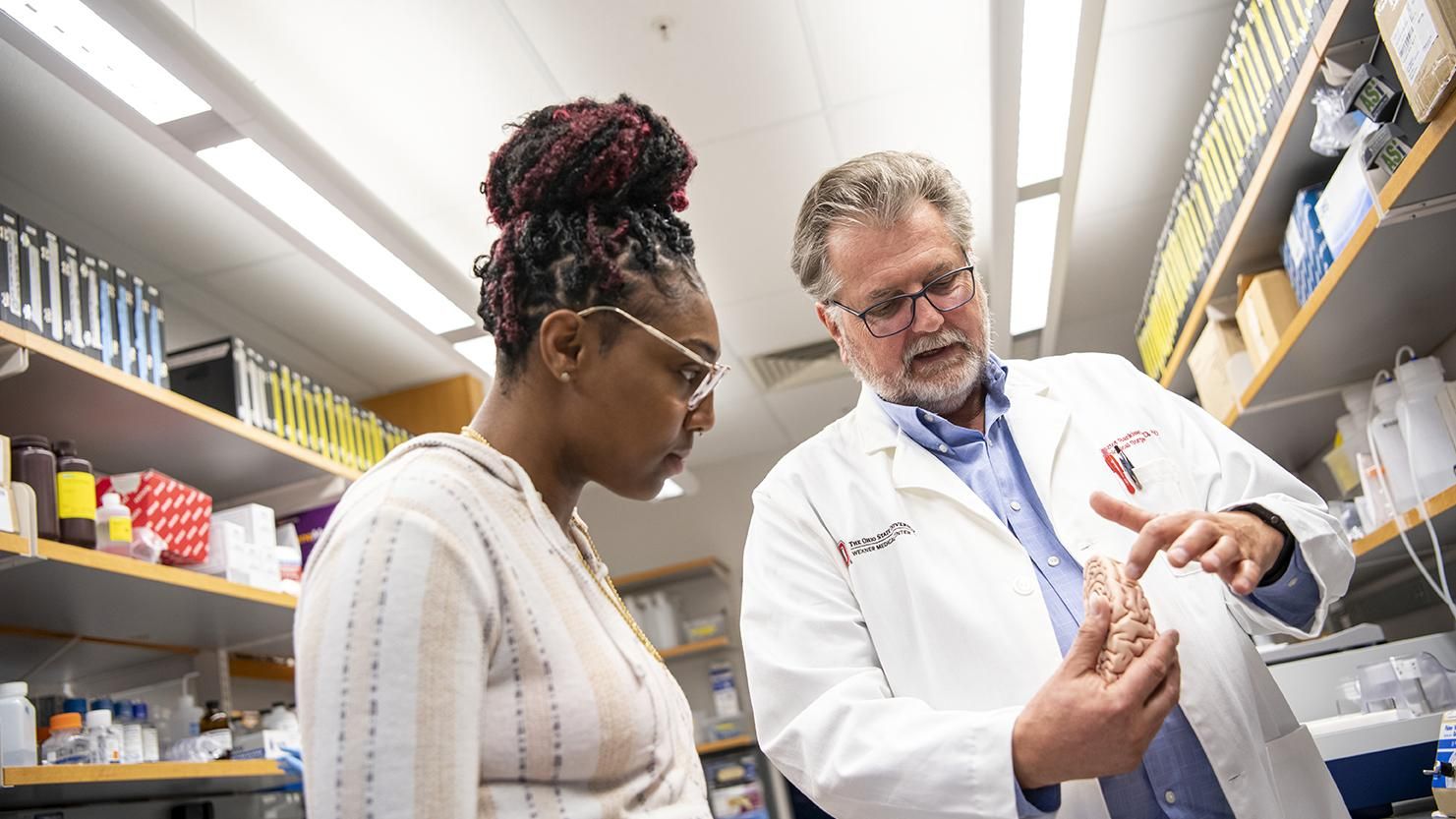 Two employees talk in a pharmacy