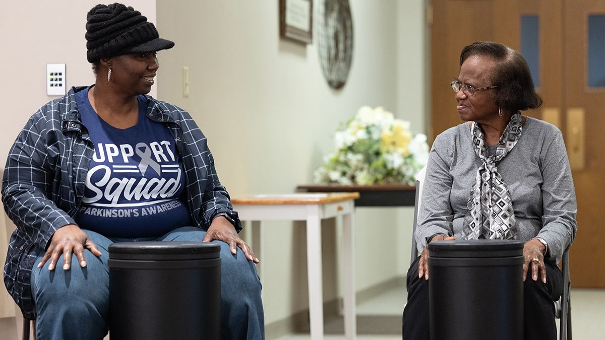 Ruthie Clemons (right) and her daughter look at one another while participating in Ohio State's Drumming for Wellness program.