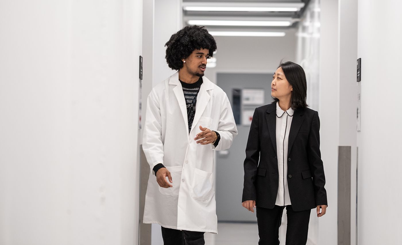 Ohio State student walks with a researcher
