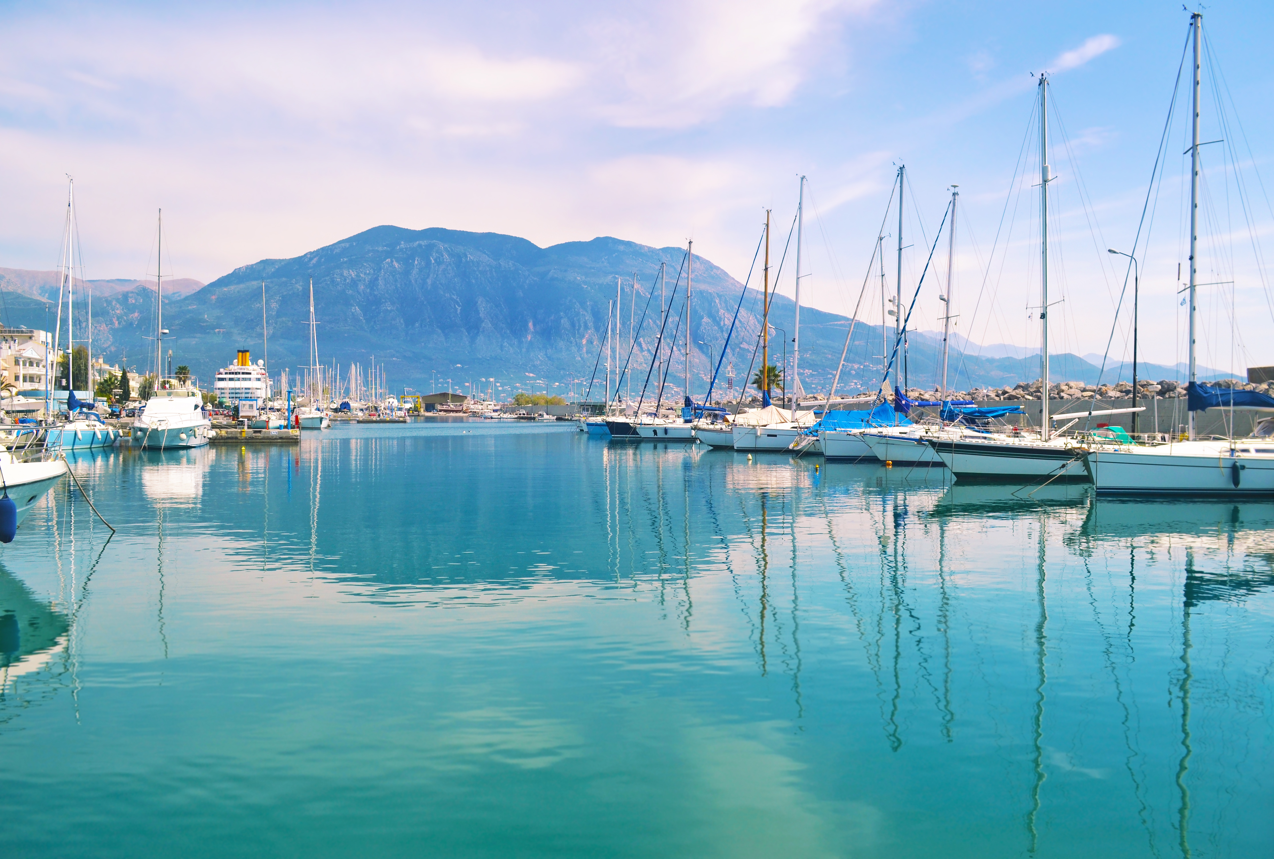 A boat dock in Greece full of sail boats 