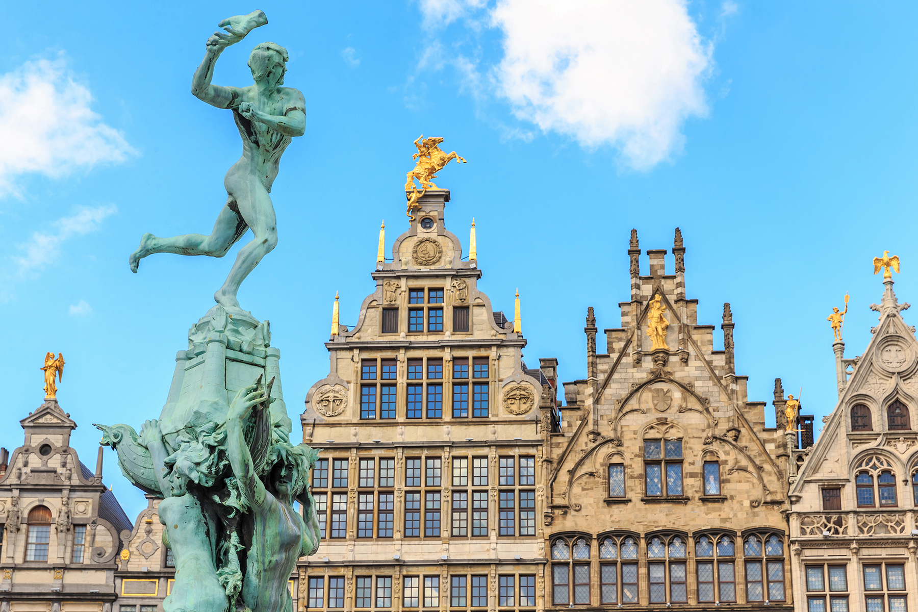 Statue in front of historic buildings in Amsterdam
