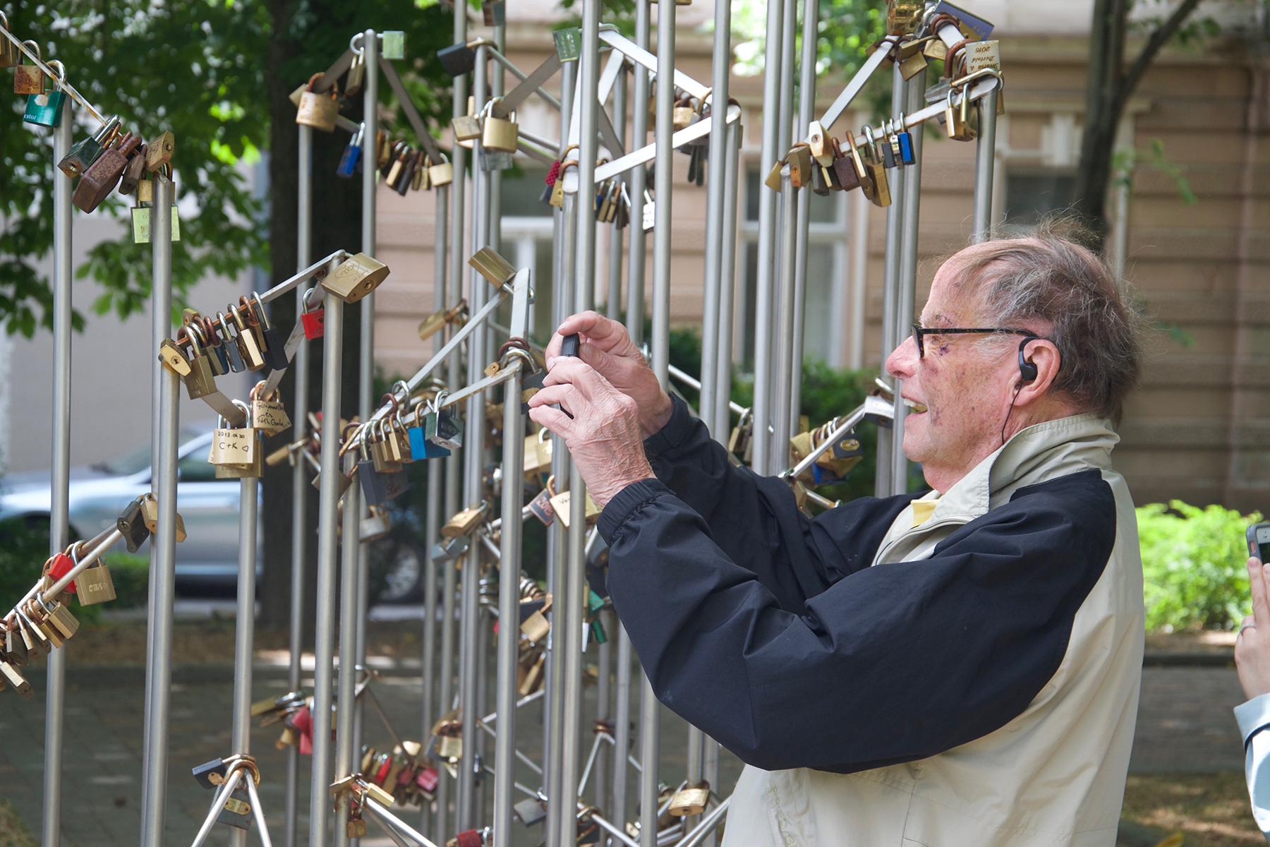 Man adding lock to gate