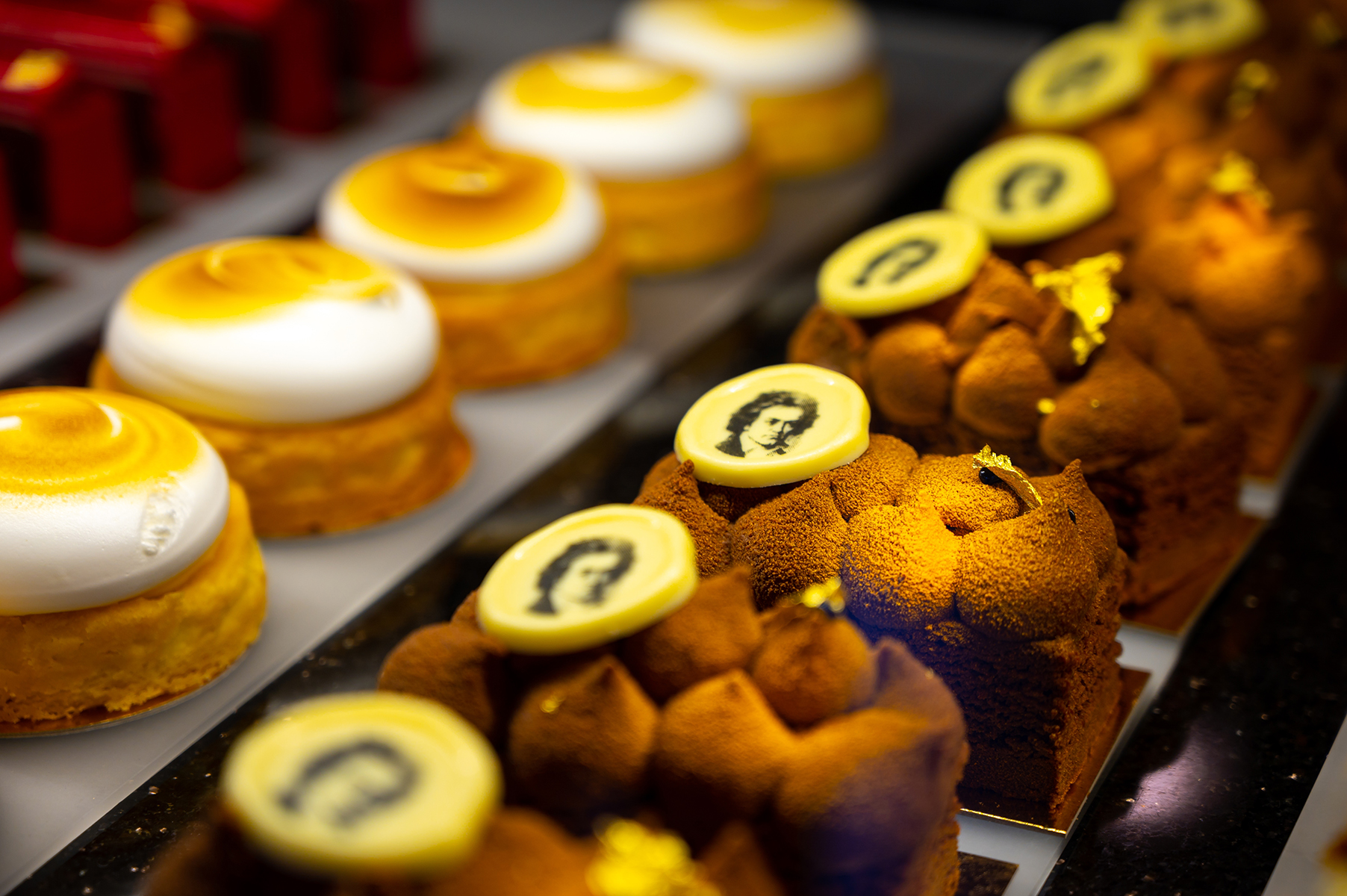 Pastries in a bakery display with mozart on them