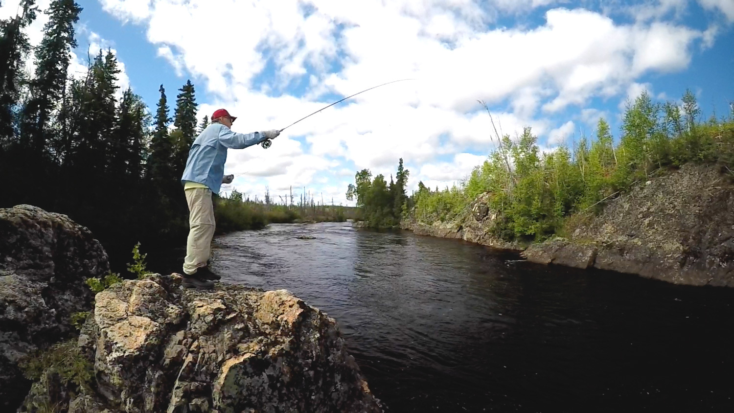 man fishing on a river