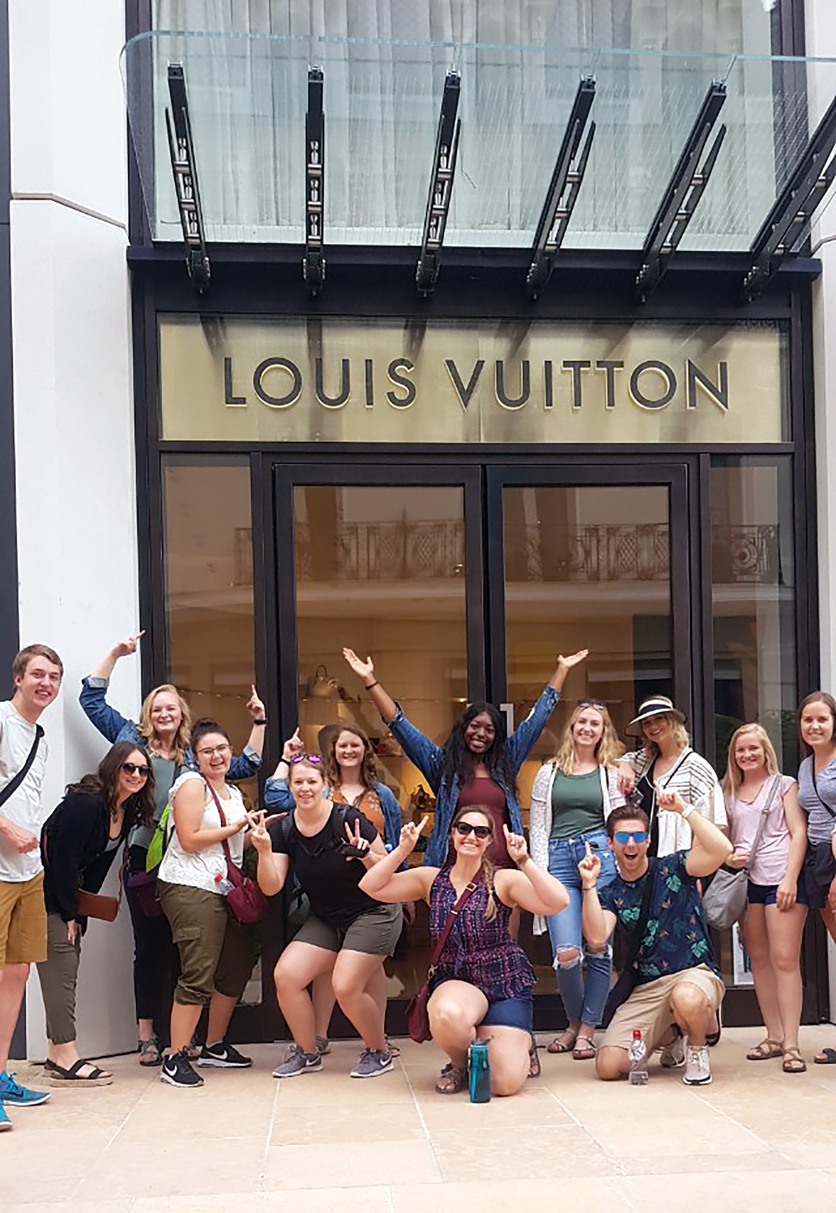 students in front of the Louis Vuitton store in Paris