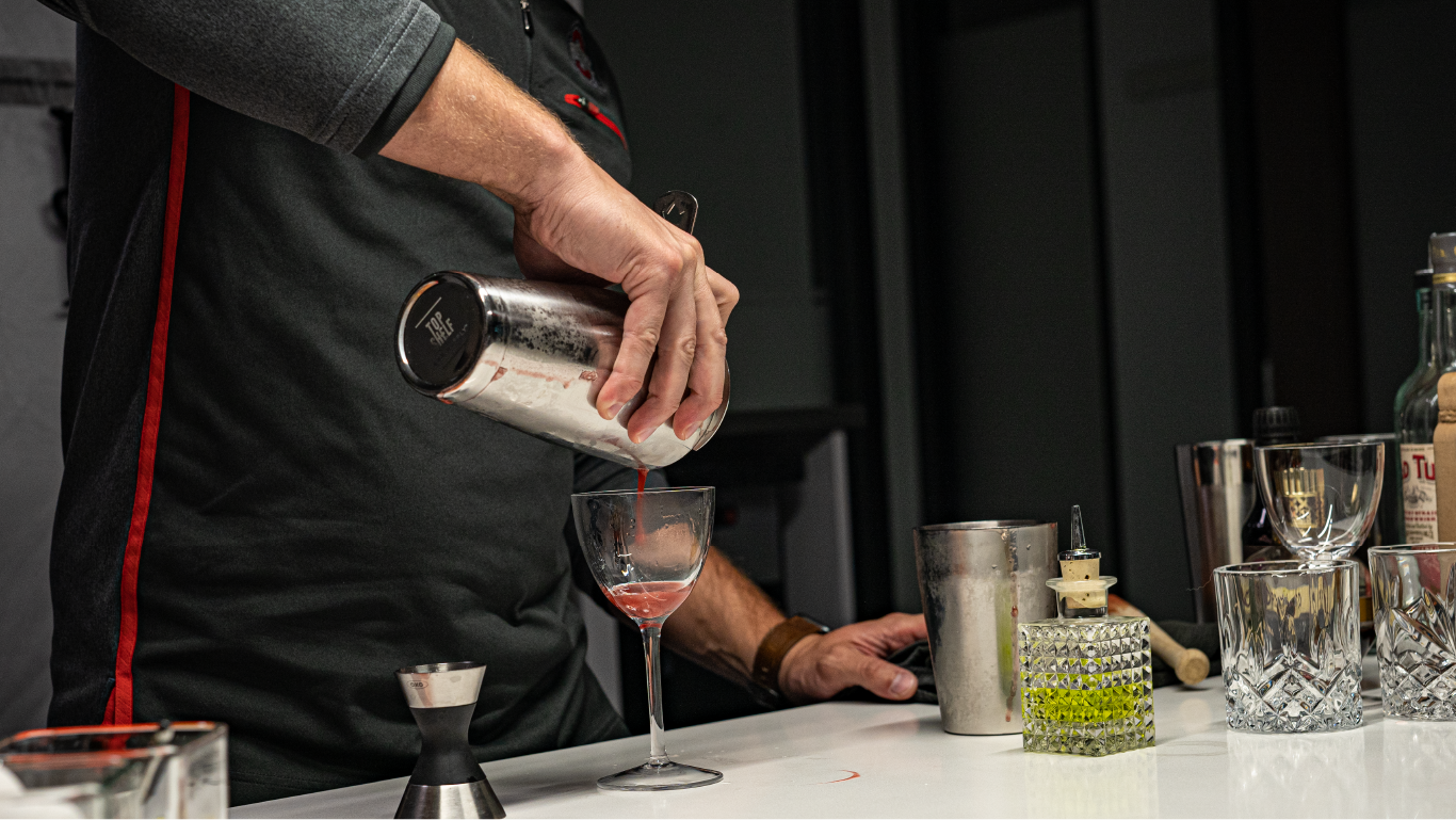 man pours a drink