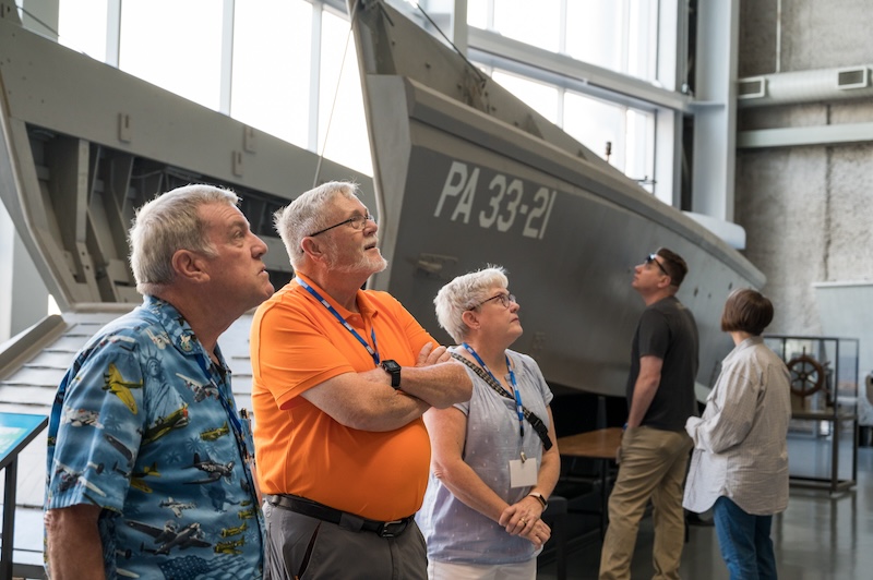 Tour participants looking up at items in the museum