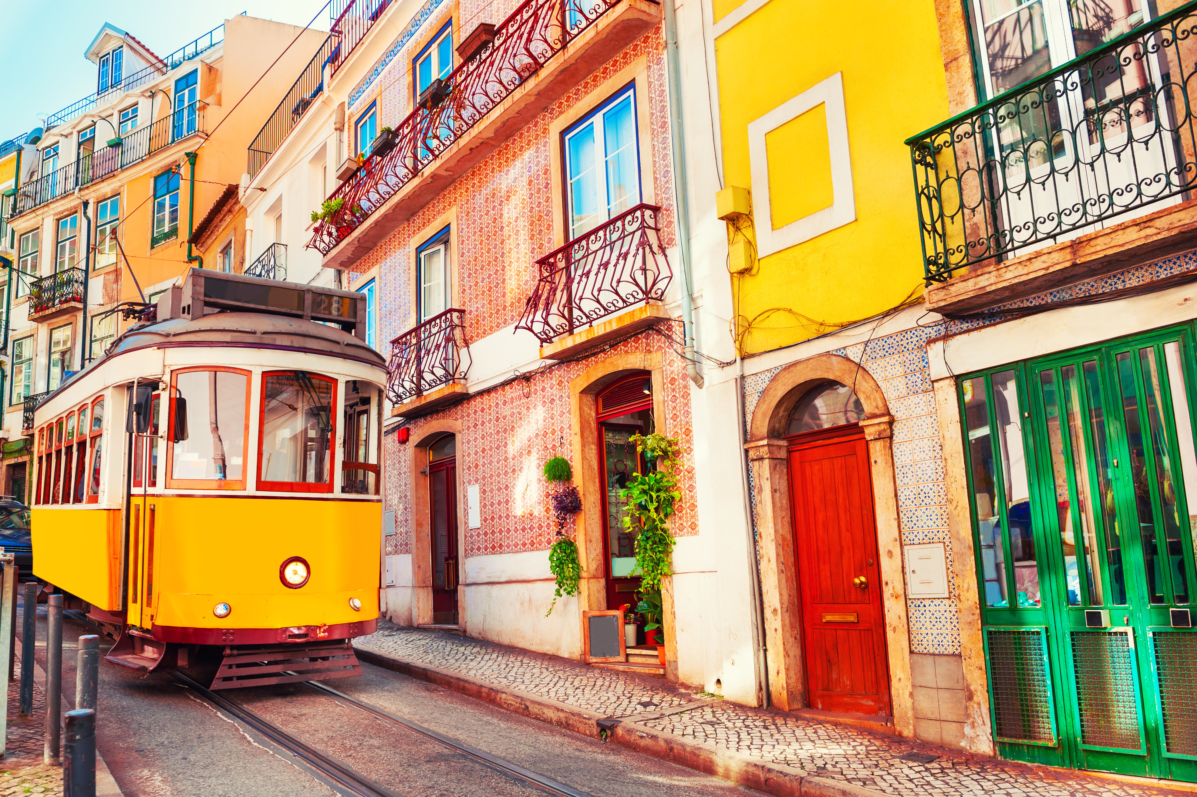 A small trolly driving through the city streets