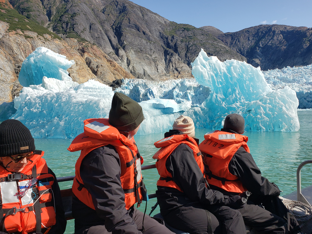 Travelers near an iceberg