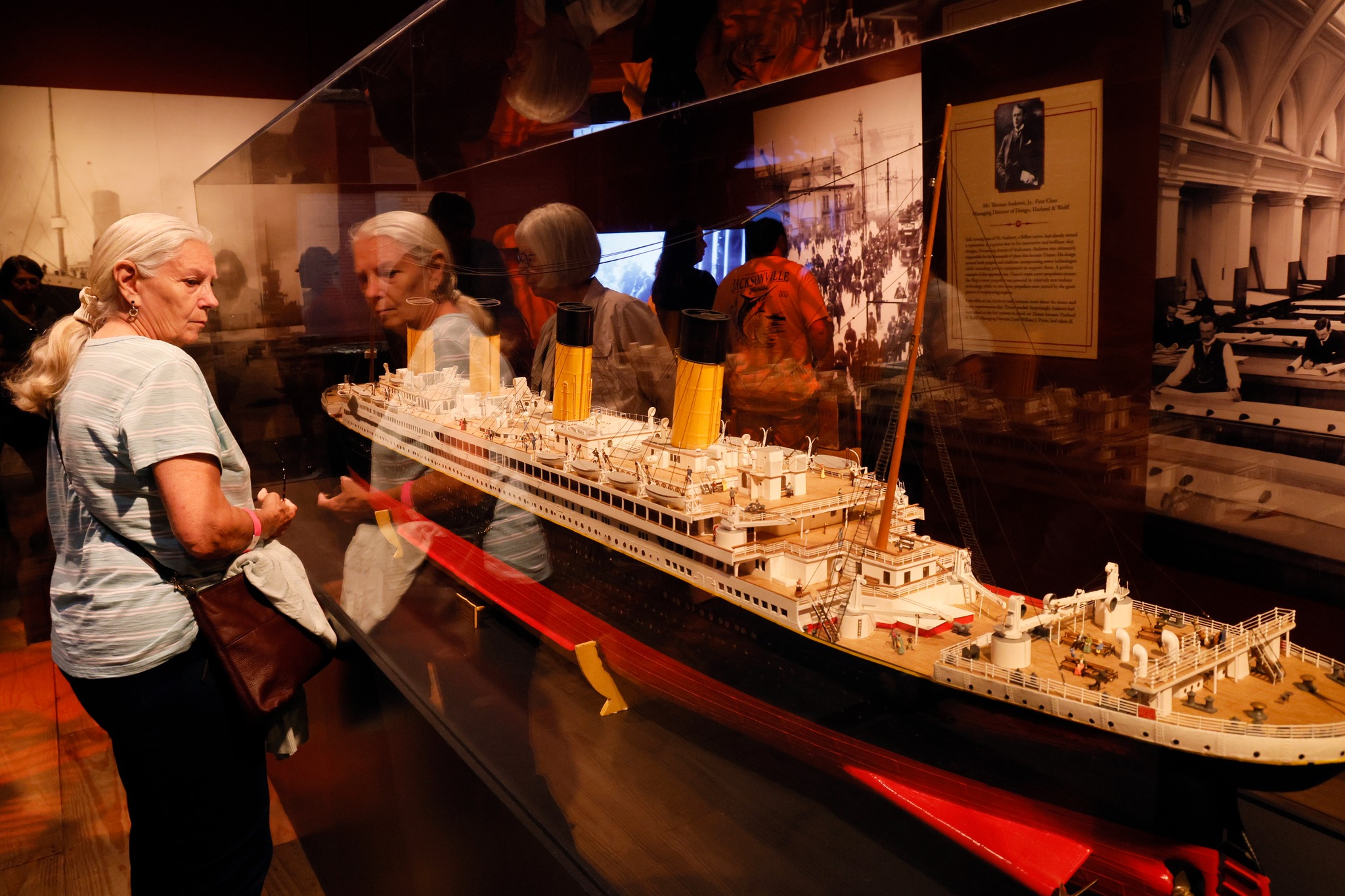 Two people observing a model display of the Titanic