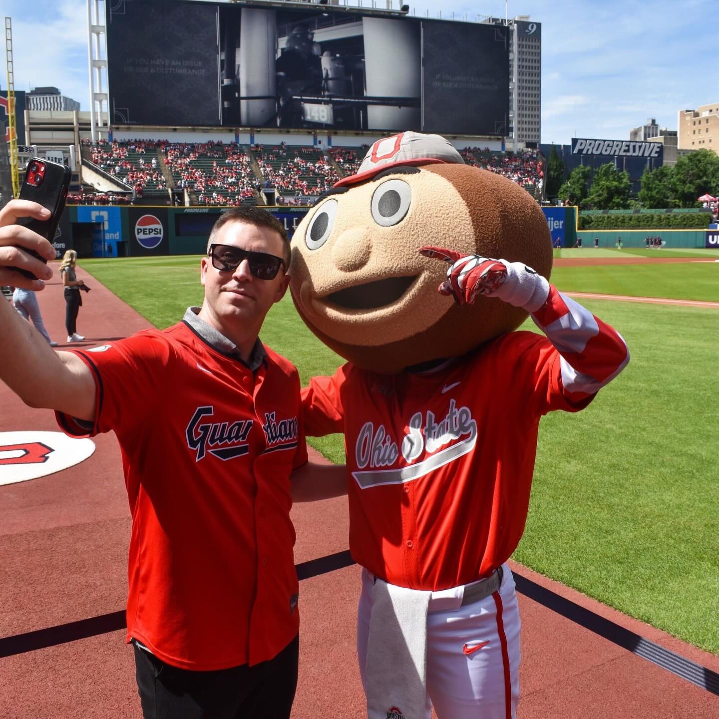 brutus buckeye taking a selfie with an adult male