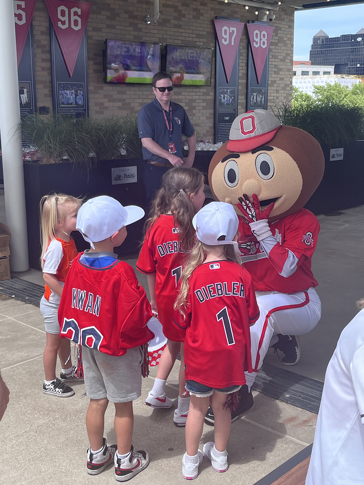 a group of kids playing with Brutus Buckeye