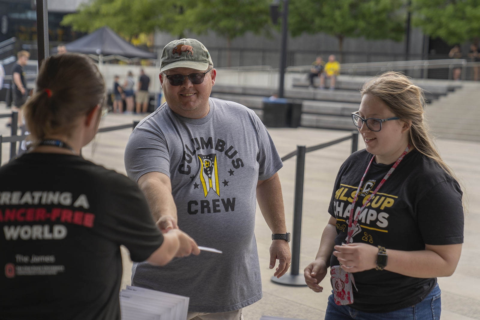 person wearing a columbus crew T-shirt checks in at an event registration table