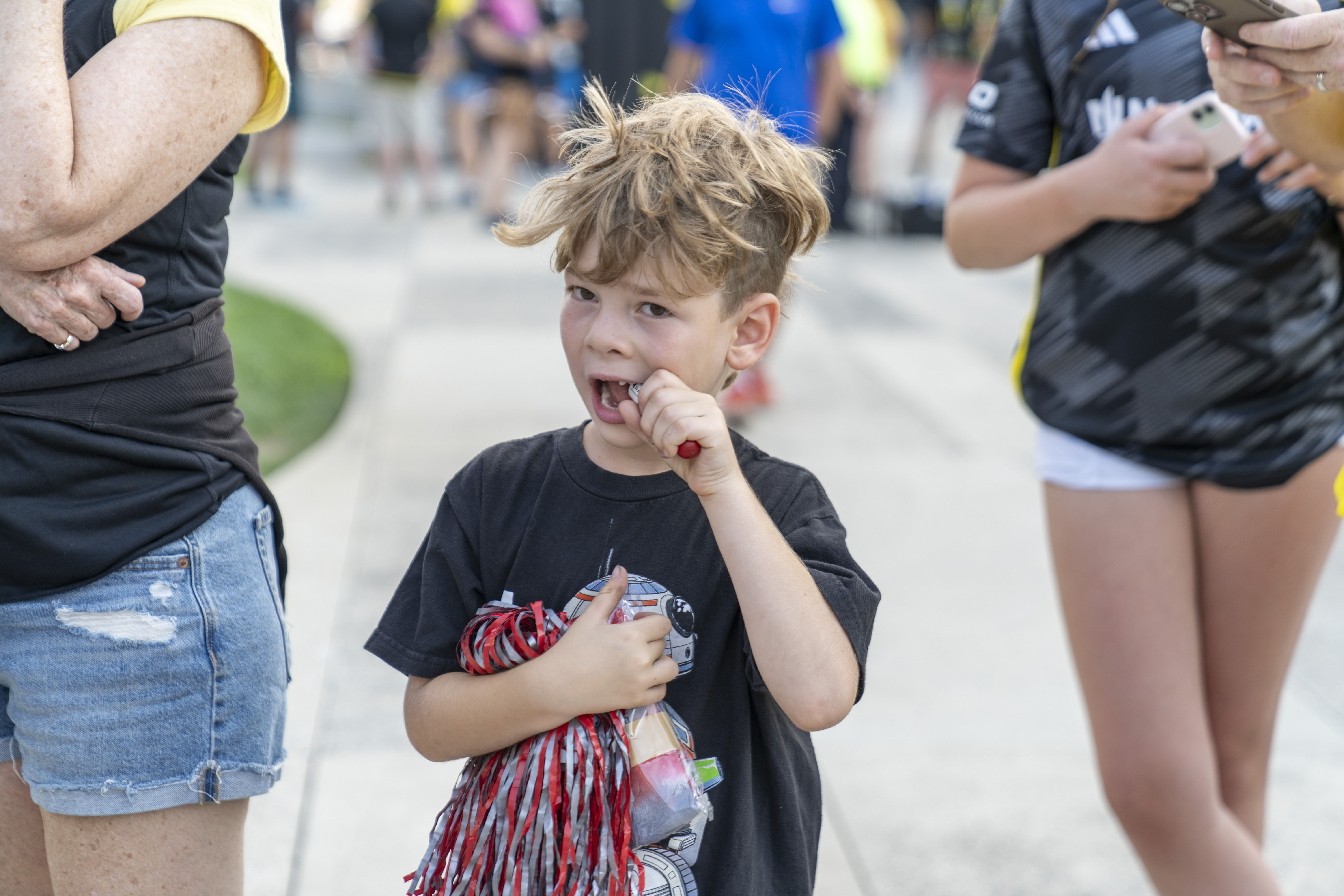 a young child eating a piece of candy