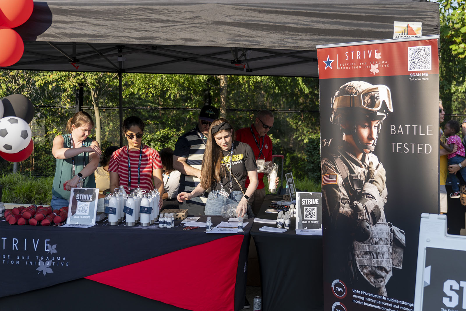 an event table decorated with resources that promote ohio state's Suicide and Trauma Reduction Initiative 