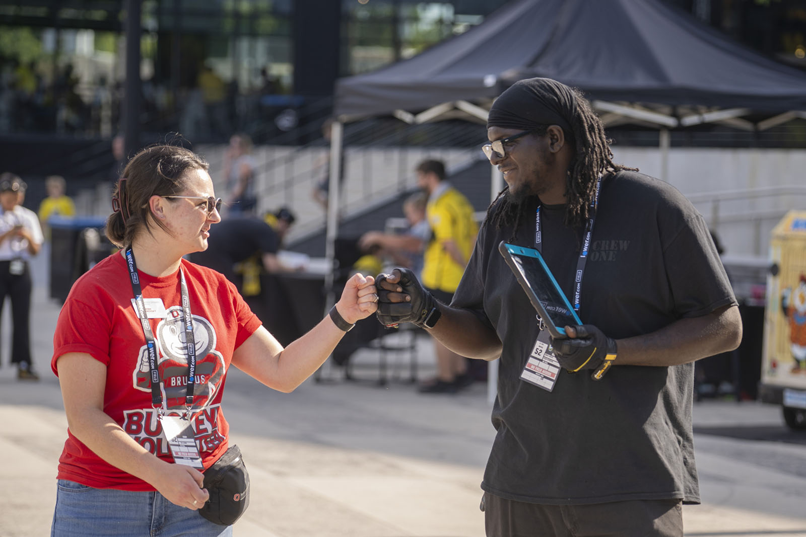 two people exchange fist bumps with one another