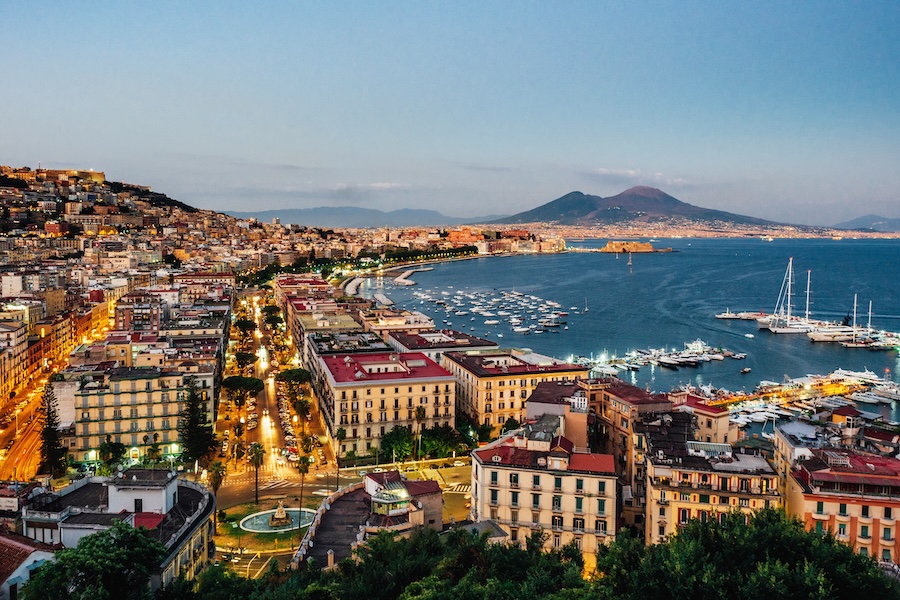 Naples harbor filled by ships and surrounded by buildings