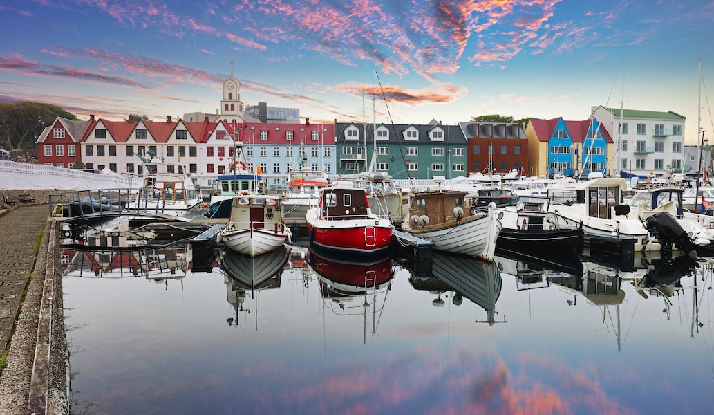 a strip of colorful buildings alongside a boat marina