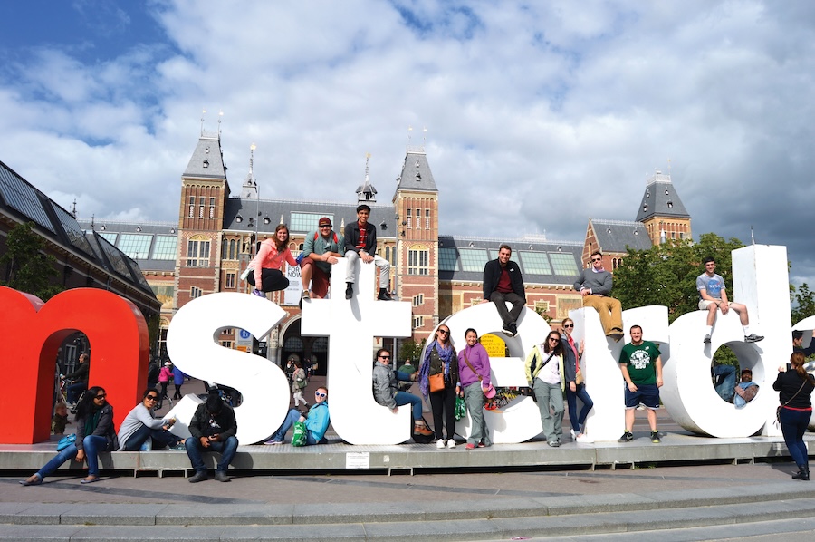 Tour participants taking a picture with the Amsterdam sign