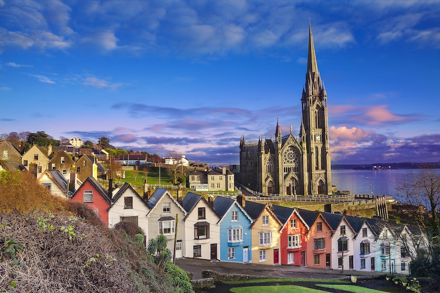 Large castle and row of colorful houses in Cork