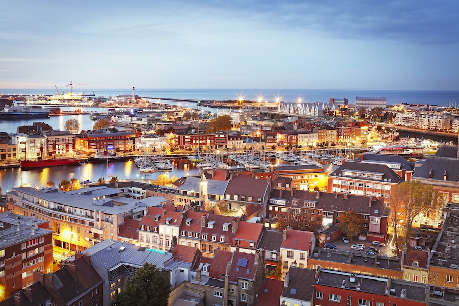 Aerial view of the city of Dunkerque lit up at sunset