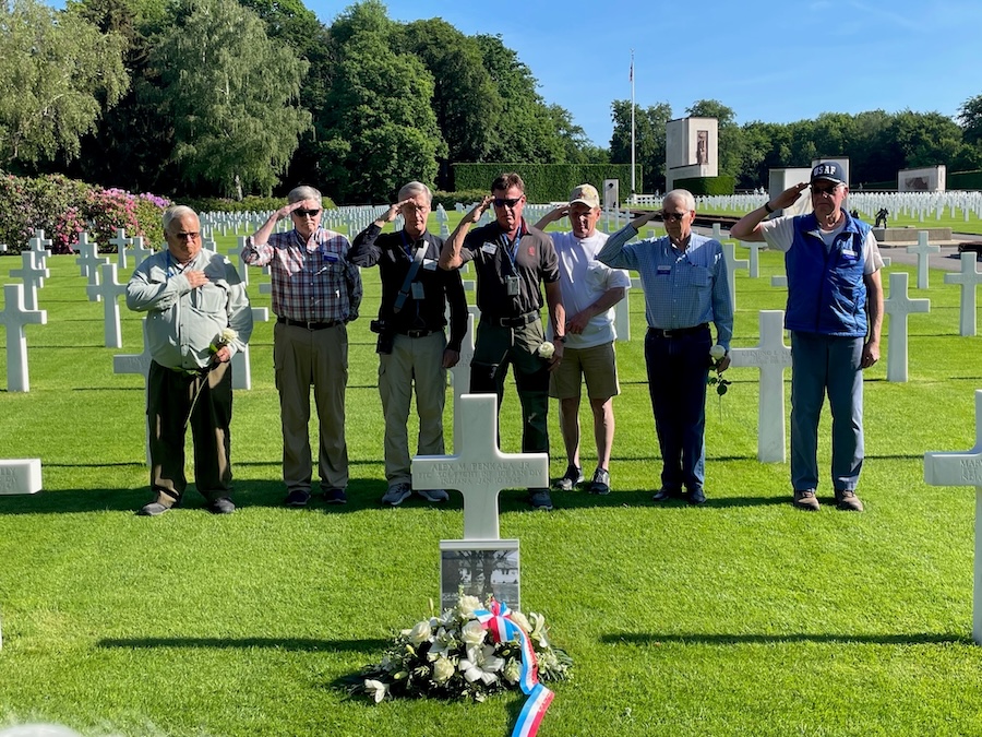 Soldiers saluting a grave