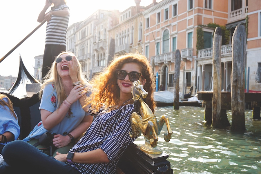 Two tour participants taking a gondola ride in Venice