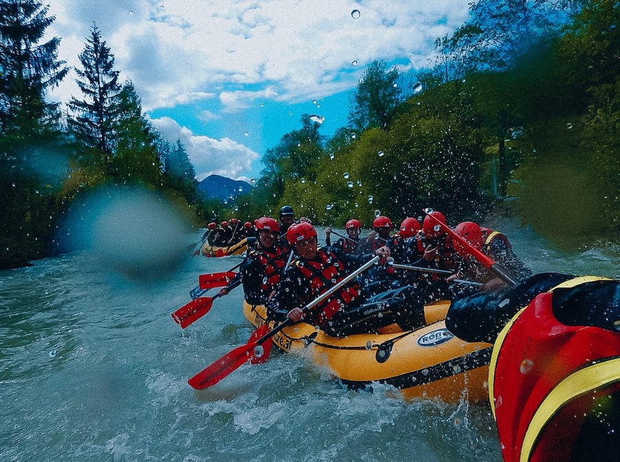 A group of travelers whitewater rafting