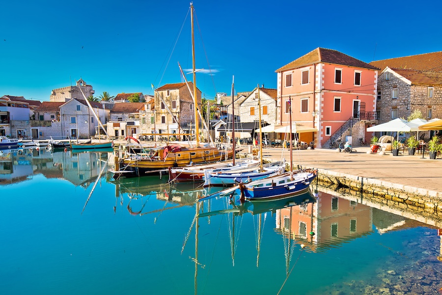 Buildings and sailboats along the port of Vrboska