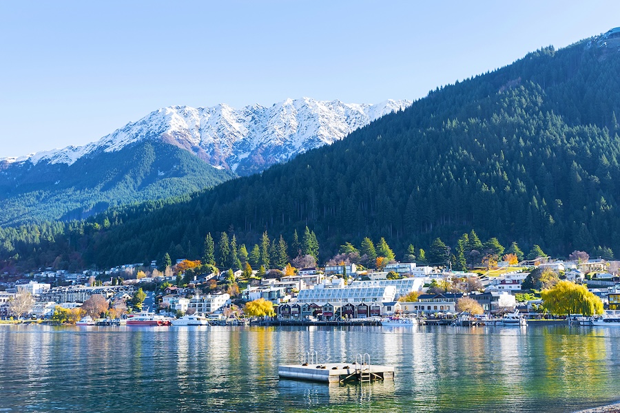 A small port in Queenstown with snow-capped mountains in the distance
