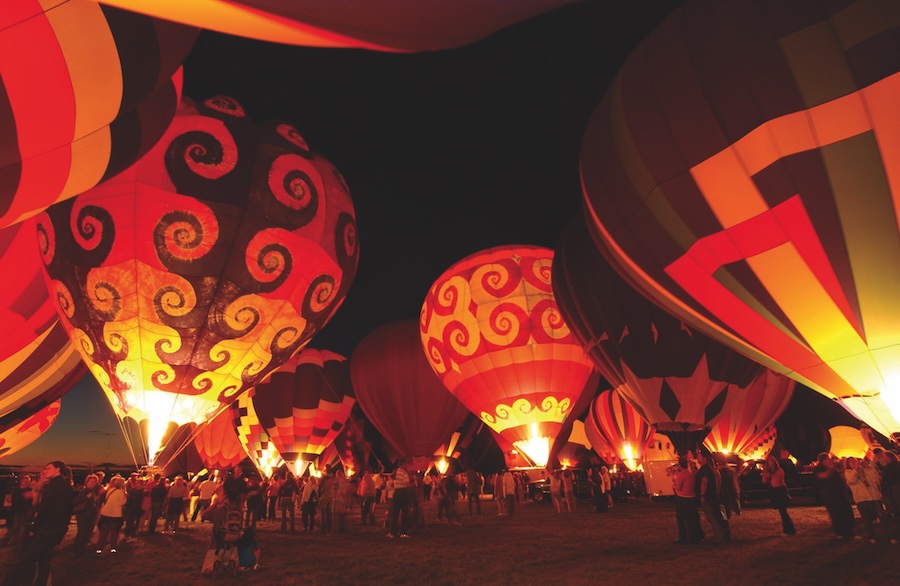 Hot air balloons glowing at night
