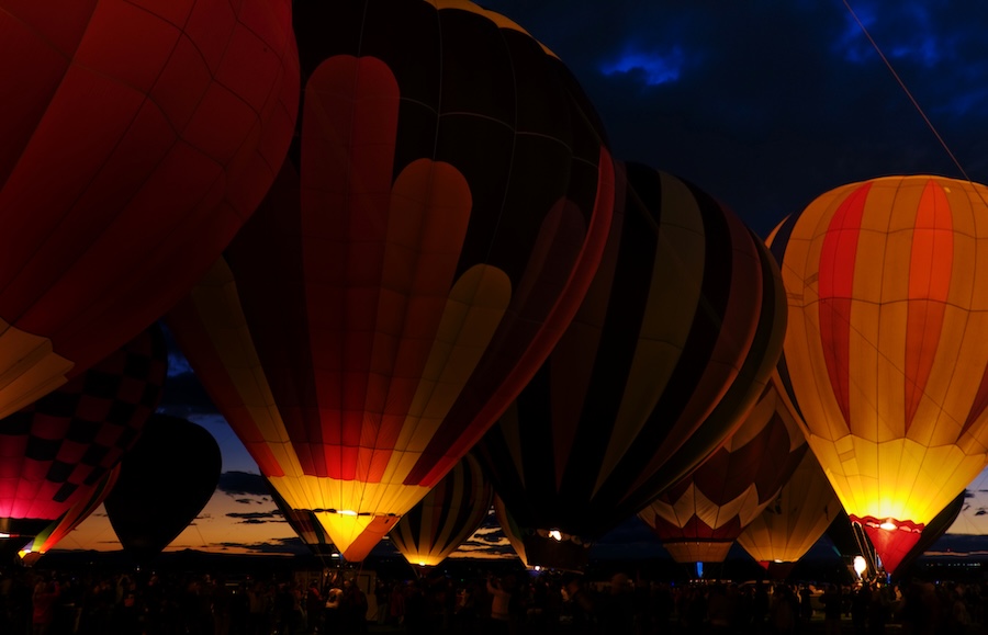 Hot air balloons glowing at night