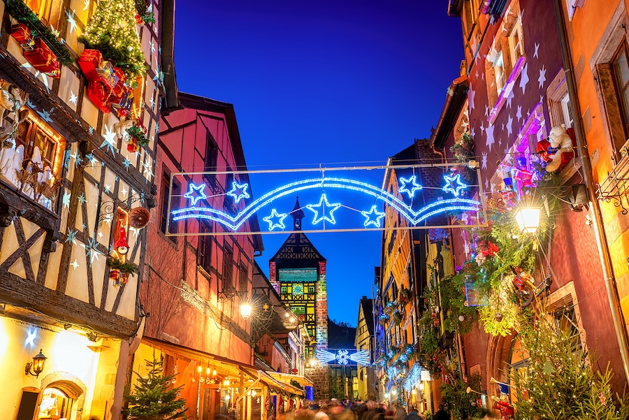 Festive holiday lights and decorations down a narrow market street