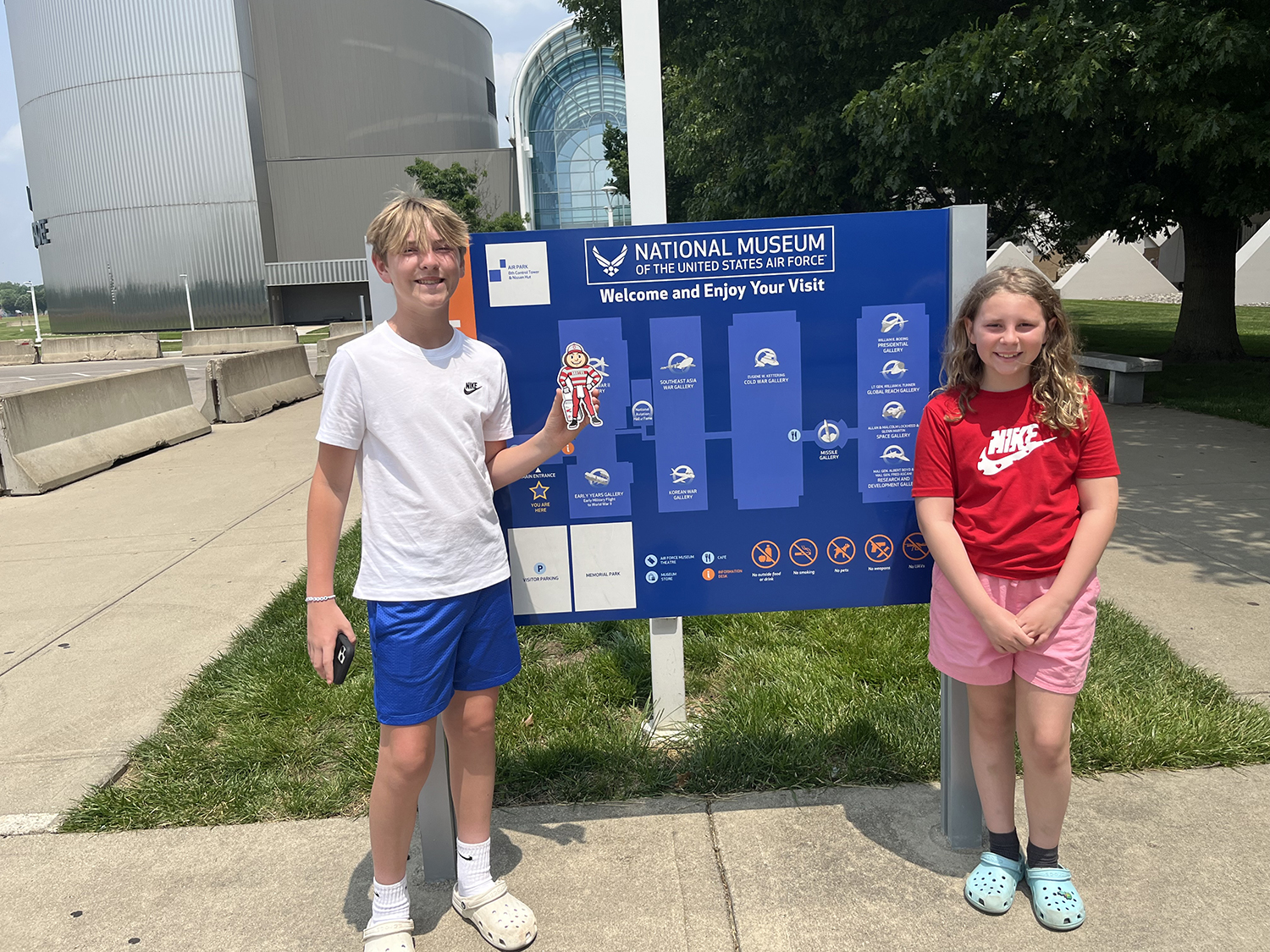 Brutus with a boy and a girl in front of the National Museum of the United States Air Force sign in Dayton, Ohio.